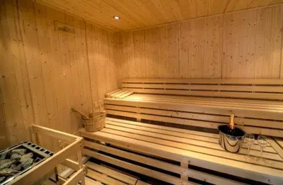 a sauna with wooden walls and a bench in it at House 25 in Looe
