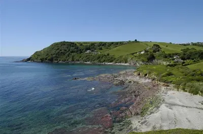 an island in the ocean next to a body of water at House 37 in Looe