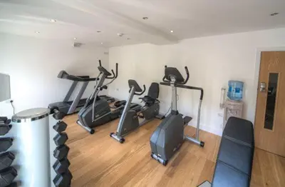 a gym with several exercise bikes in a room at House 47 in Talland