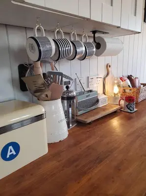 a kitchen with a counter with a mixer and utensils at Monroe Horsebox Glamping in Porthleven