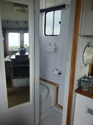 a small bathroom with a toilet and a sink at Monroe Horsebox Glamping in Porthleven