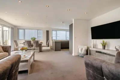 a living room with a couch and a tv on a wall at 2 Bed in Newquay oc-b32399 in Holywell Bay