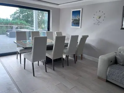 a dining room with a table and chairs at Creek View House in Feock