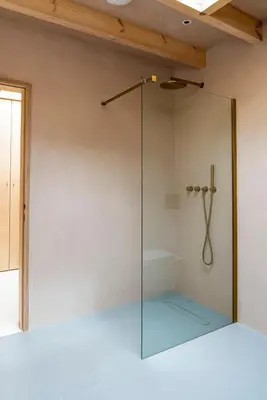 a shower with a glass door in a room at The Architects Treehouse in Mount Hawke