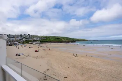 a group of people on a beach near the ocean at 15 Barnaloft in St Ives