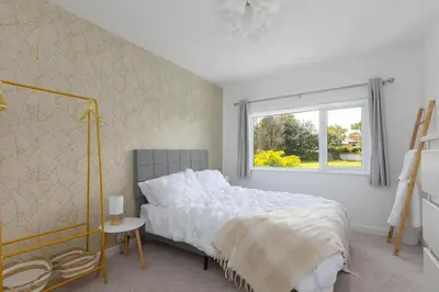 a bedroom with a bed and a window at Pebble in Carbis Bay