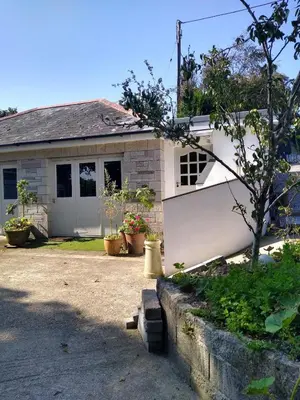a house with a white fence in front of it at The Birch House in Saint Columb Major