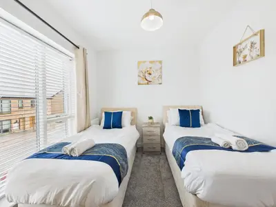 two twin beds in a room with a window at No4 Harveys Yard By Signature Stays - Luxury Stay - Beach - Parking in Hayle