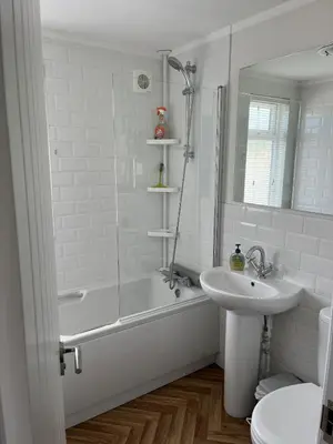 a bathroom with a tub and a sink and a shower at Lodge in St Merryn in St Merryn