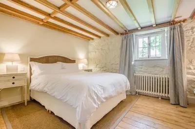 a bedroom with a large white bed and a window at 6 Bed in Tresillian oc-t32987 in Newlyn East