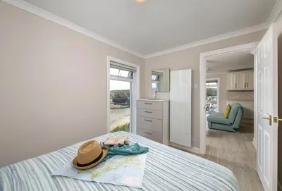 a bedroom with a bed with a hat on it at The Gatehouse Apartment in Portreath