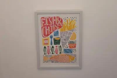a framed picture of fish and chips on a wall at Looe Cottage - Seaside views log fire sleeps 4 in Looe