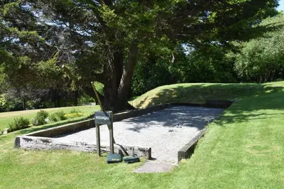 a park with a tree and a sign in the grass at 1 Bed in Two Waters Foot oc-a27332 in Warleggan