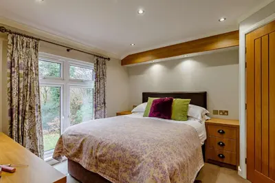 a bedroom with a large bed and a window at 3 Bed in Two Waters Foot oc-r27336 in Cardinham