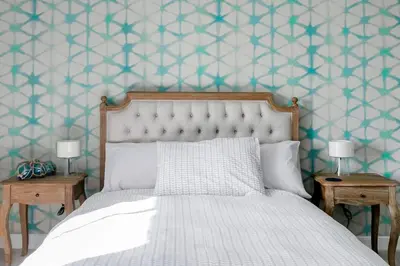a bedroom with a bed and two nightstandumentsuments at Grade II Listed 17th-Century Rectory in Cornwall in Perranuthnoe
