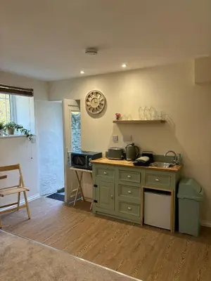 a kitchen with a stove and a counter top at Cute Cornish Cottage in Saint Germans
