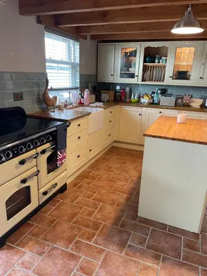 a kitchen with white cabinets and a stove at Buddleia Cottage Trewoon, St Austell in St Austell