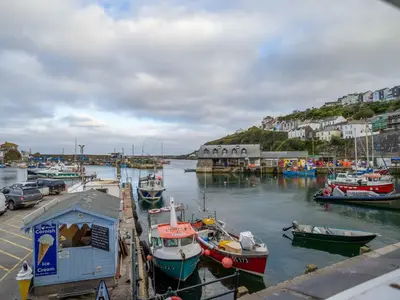 a group of boats are docked in a harbor at Holiday Home Tregony House 1 Bedroom by Interhome in Mevagissey