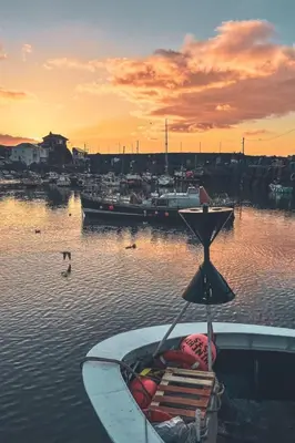 a boat sitting in the water at a harbor at Holiday Home Tregony House 1 Bedroom by Interhome in Mevagissey