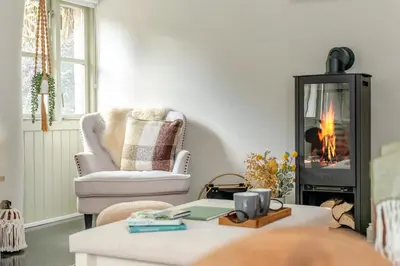 a living room with a fire in a fireplace at 1 Bed in Newquay oc-c33290 in Saint Columb Major