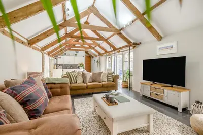 a living room with couches and a flat screen tv at 1 Bed in Newquay oc-c33290 in Saint Columb Major
