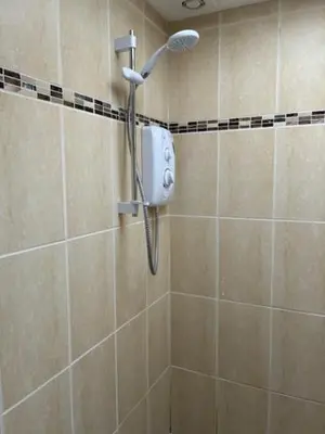 a shower with a shower head in a bathroom at Park Rd in Redruth