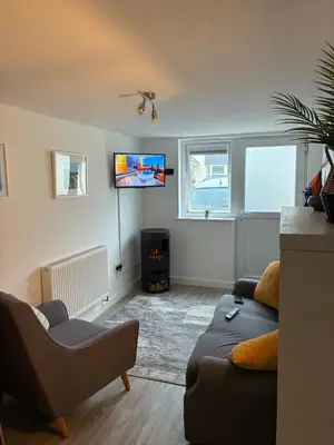 a living room with a couch and a tv at Park Rd in Redruth