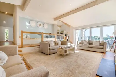 a living room with two couches and a table at 5 Bed in Rock oc-m33185 in Roche