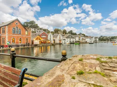 a view of a river with houses and a bench at 1 Bed in Fowey oc-p33360 in Fowey