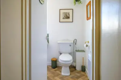 a bathroom with a white toilet in a room at Danny Cottage in Saint Dennis