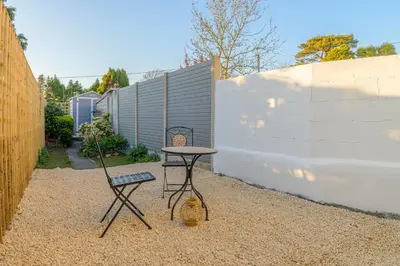 a small table and two chairs in a backyard at Danny Cottage in Saint Dennis