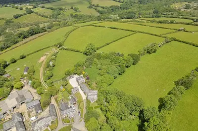 an aerial view of a mansion in a field at Finest Retreats - Rowella Cottage in Blisland