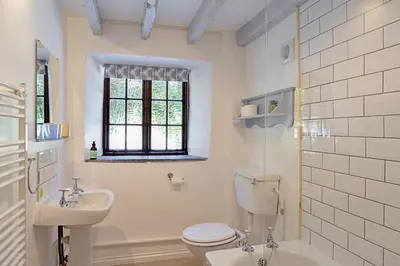a white bathroom with a toilet and a sink at Finest Retreats - Rowella Cottage in Blisland