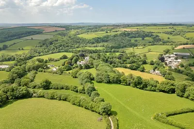 an aerial view of a green field with trees at Finest Retreats - Demelza Cottage in Blisland