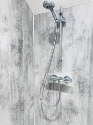 a shower with a shower head on a wall at Rising Sun Inn - Rough Tor in Altarnun
