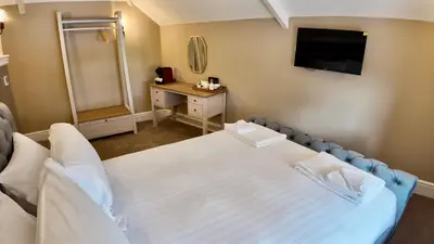 a hospital room with a bed and a television at Rising Sun Inn - Rough Tor in Altarnun