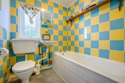 a bathroom with a tub and a toilet and a sink at 5 Bed in Trebetherick oc-t33296 in Polzeath