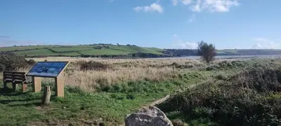 a sign on the side of a hill with a field at Peace Haven in Par