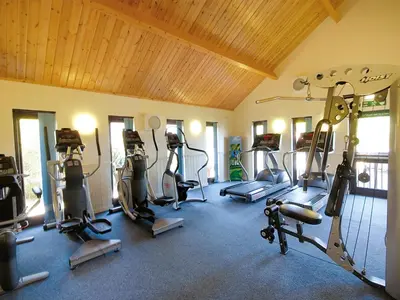 a gym with several tread machines in a room at Landal Gwel an Mor in Portreath