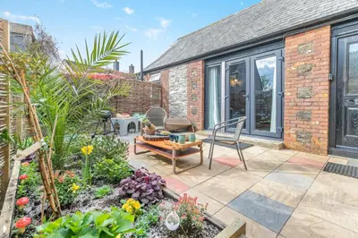 a patio with a table and chairs in a garden at 1 Bed in Menheniot oc-t29268 in Menheniot