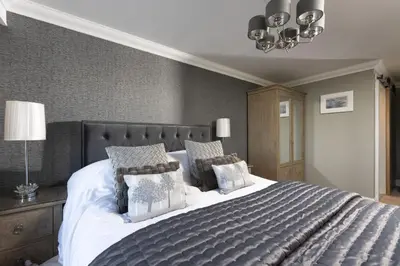 a bedroom with a large bed with pillows at Crystal View, Compass Point - Sea View - Free WiFi & Parking - Close to Beach in Carbis Bay