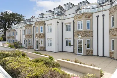 an exterior view of a large white building at Crystal View, Compass Point - Sea View - Free WiFi & Parking - Close to Beach in Carbis Bay