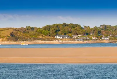 a view of a beach with houses in the background at Skylark in Bodmin