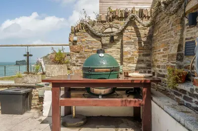 a green pot sitting on top of a wooden table at The Tide House in Portreath