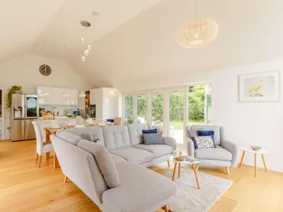 a living room with a couch and a table at 3 Bed in Saltash oc-88525 in Landrake