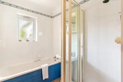 a bathroom with a tub and a sink at Peaceful cottage with views - Fairview Cottage in Mylor Bridge