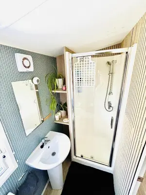 a bathroom with a shower and a sink at Holiday Home with Hot Tub Cornish Country SeaSide in Porth