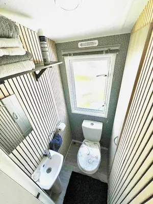 a small bathroom with a toilet and a sink at Holiday Home with Hot Tub Cornish Country SeaSide in Porth