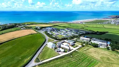 an aerial view of a house next to the ocean at Finest Retreats - Olive Tree in Widemouth Bay