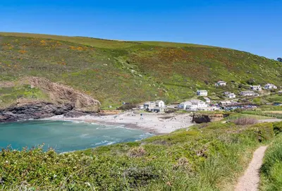 a view of a beach with houses on a hill at Little Penrose Cottage in Bude